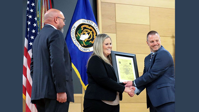 Eric Hughes (right) receives the Product Manager Multi-Domain Sensing System Charter from Project Director Sensors-Aerial Intelligence Julie Isaac