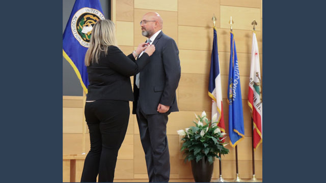 Eric Hughes (right) receives the Product Manager Multi-Domain Sensing System Charter from Project Director Sensors-Aerial Intelligence Julie Isaac