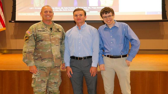 Defense Civilian Training Corps Interns Lake Gohlke and William Buinicki pictured here with former Program Executive Officer Intelligence, Electronic Warfare and Sensors, Brig. Gen. Ed Barker during a town hall on July 9. (U.S. Army)